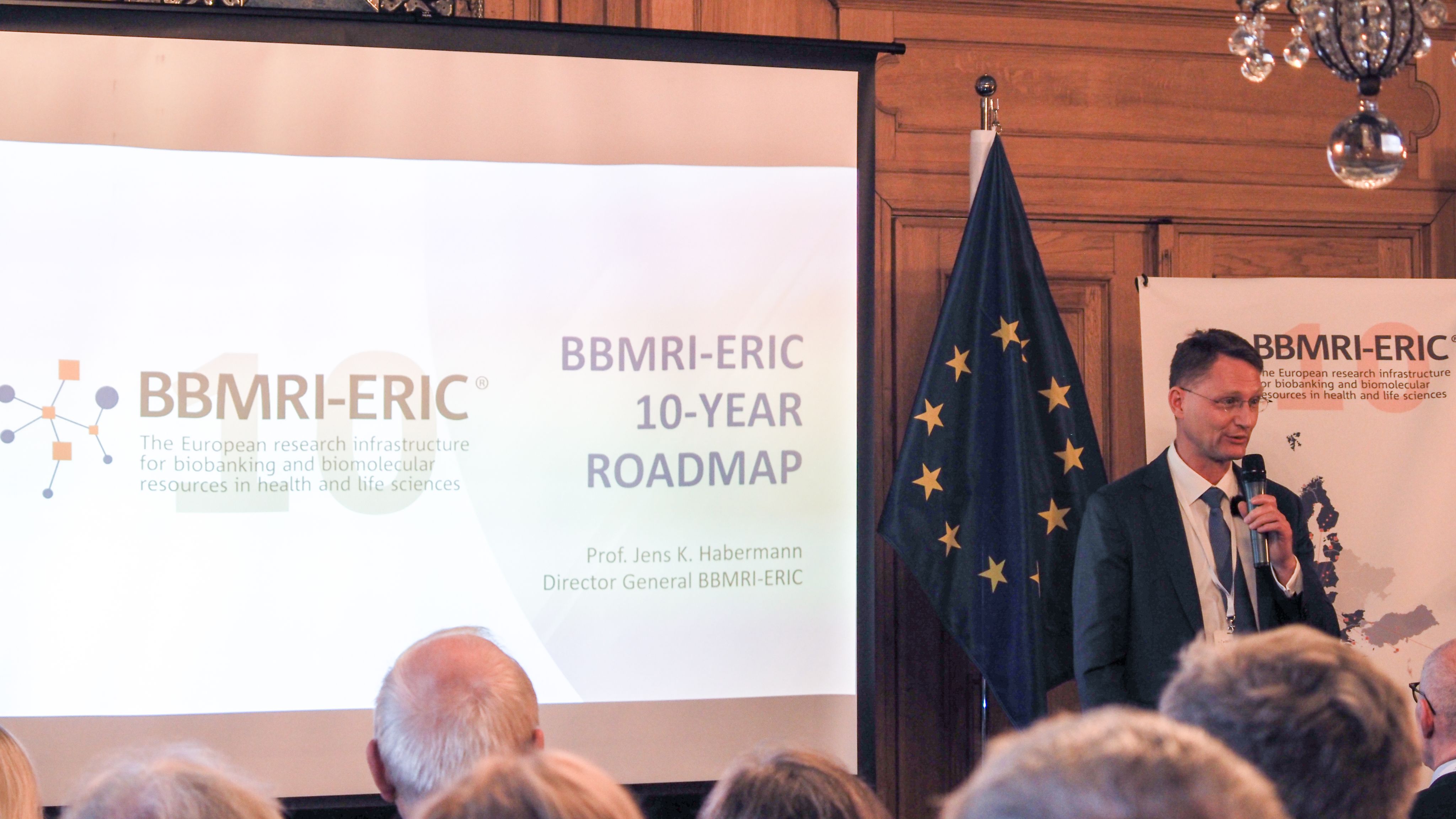 The picture of a white man presenting to an audience