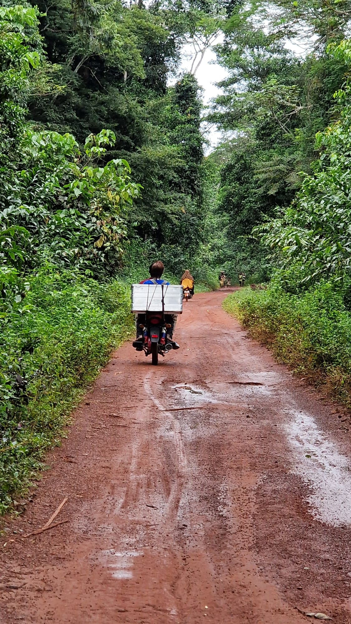 Man riding motorbike down dirt road