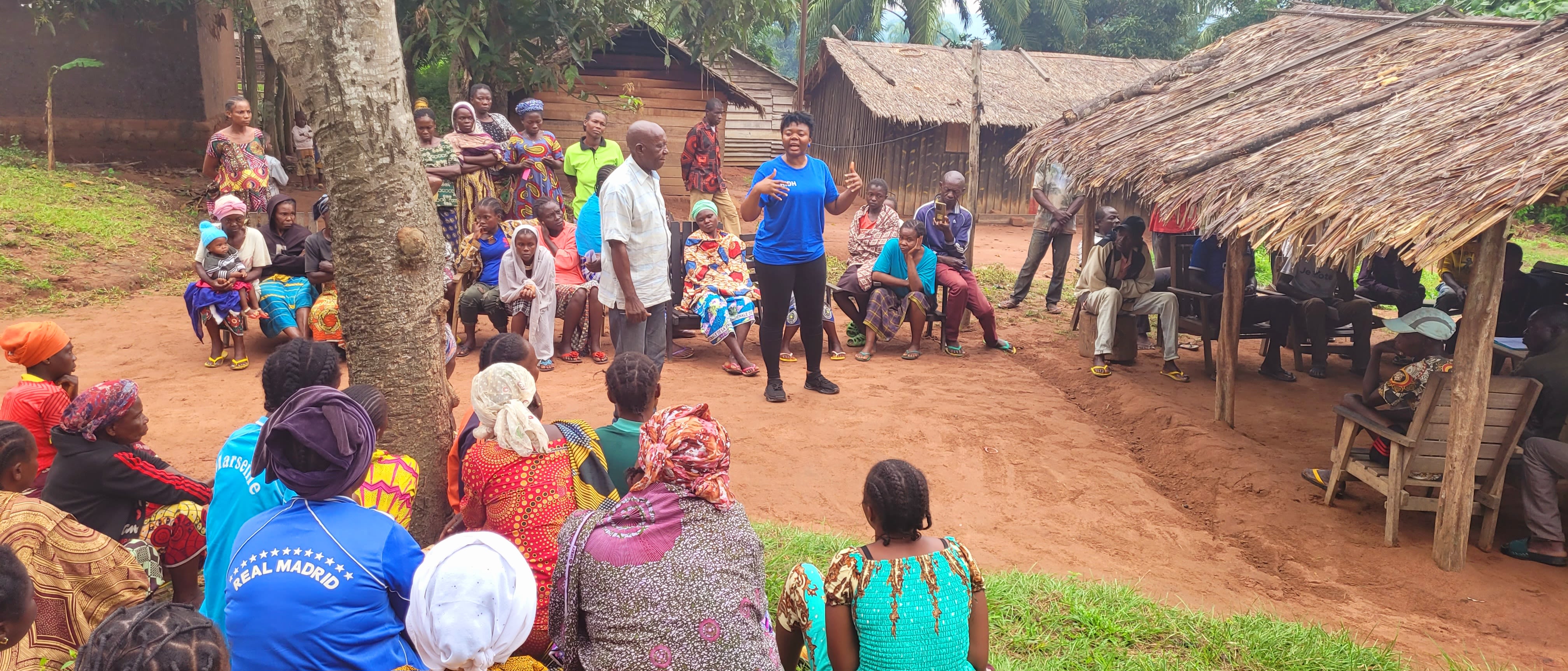 Villagers gathering to listen to a speaker